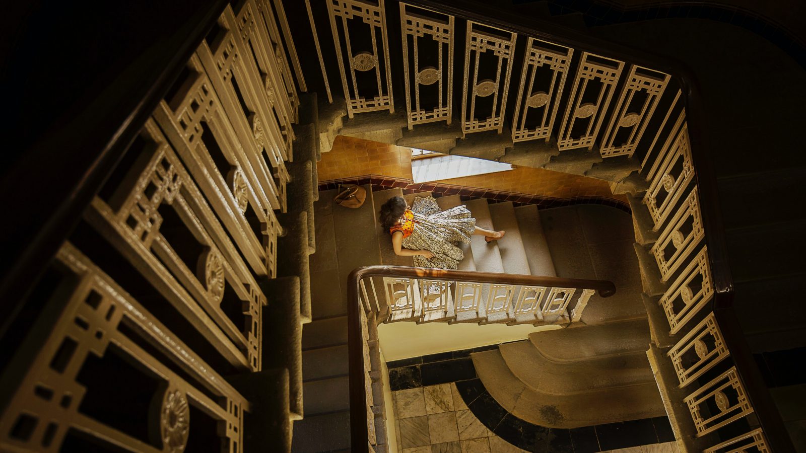 high angle photography of woman sitting on stairway